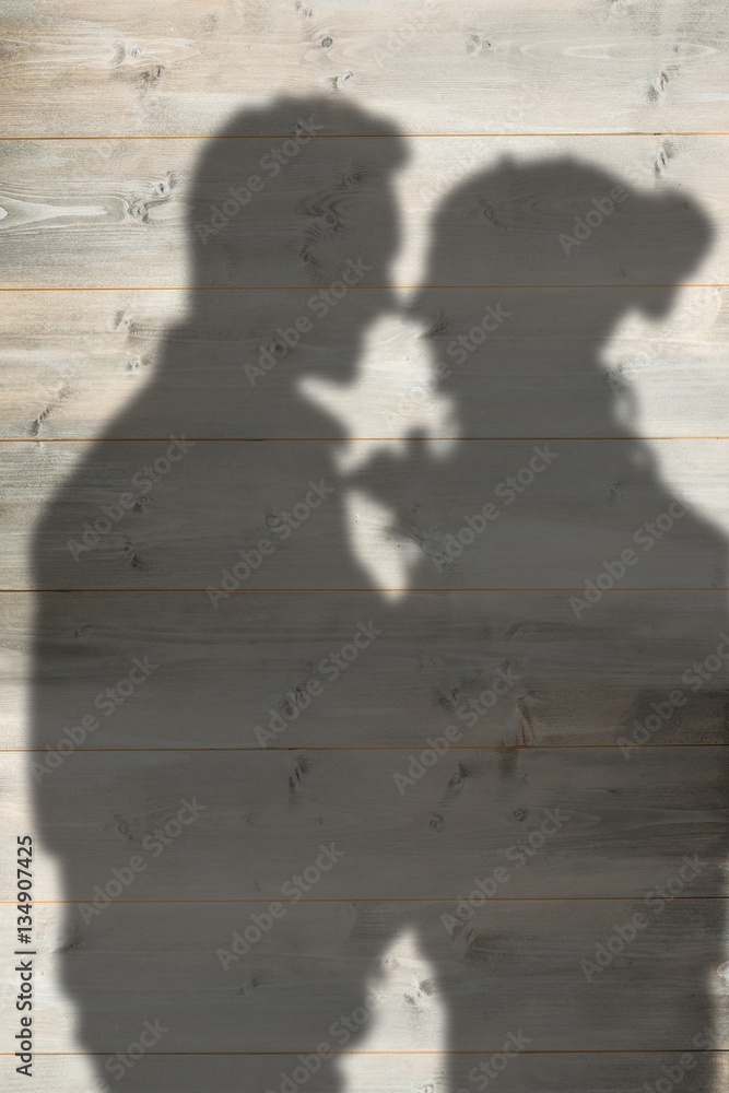 Composite image of young couple holding  flowers 