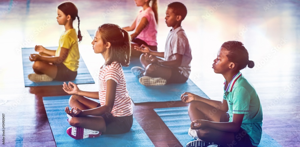 School kids meditating during yoga class