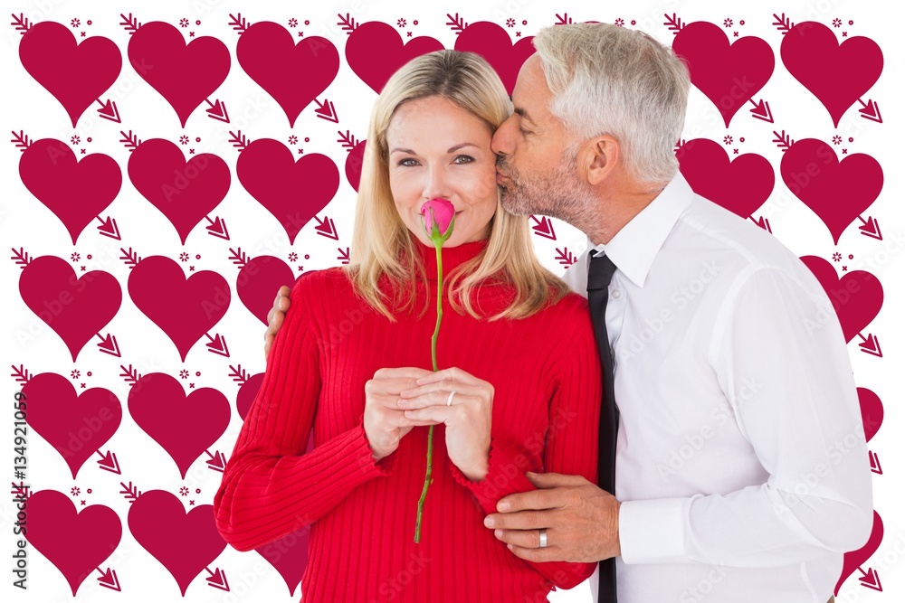 Composite image of handsome man giving his wife a kiss on cheek