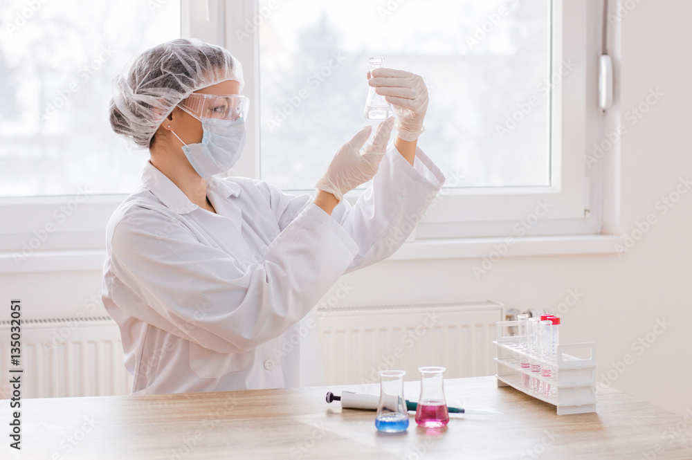 Scientist with test tube making research in clinical laboratory