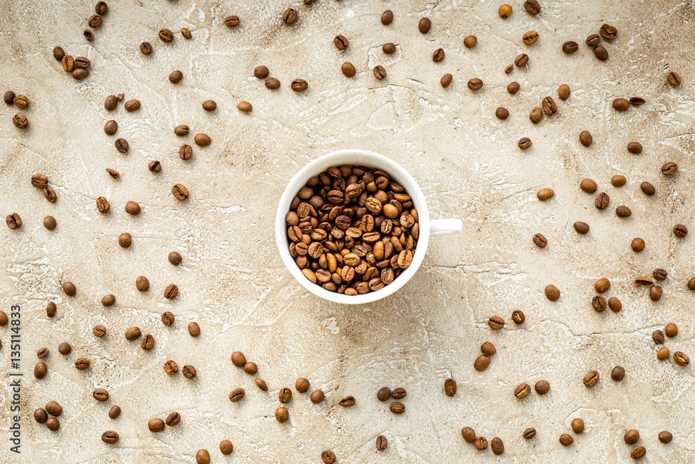 coffee beans on gray with coffe cup table top view