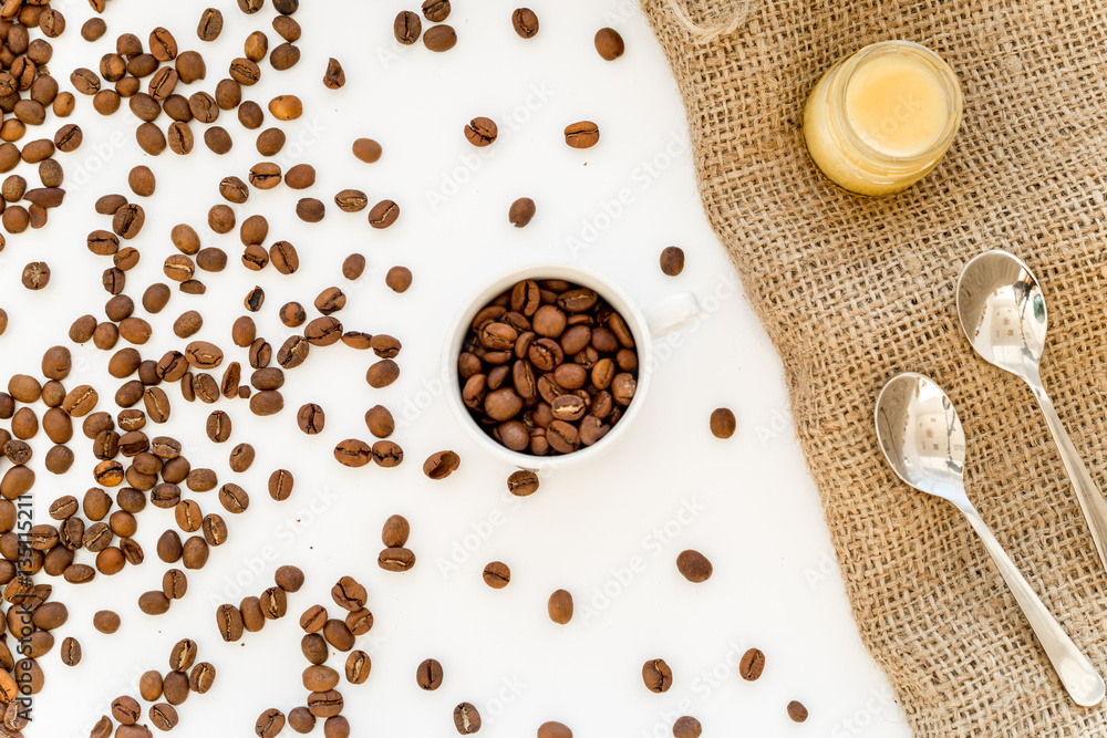 beans, ground coffee and sugar cane on linen cloth