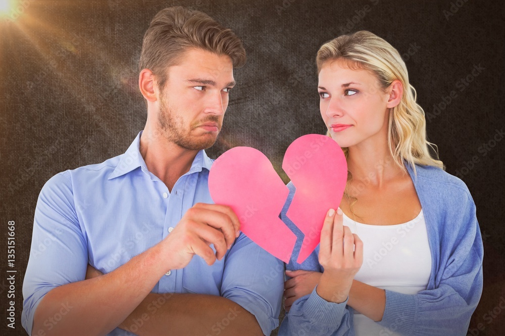 Composite image of couple holding two halves of broken heart