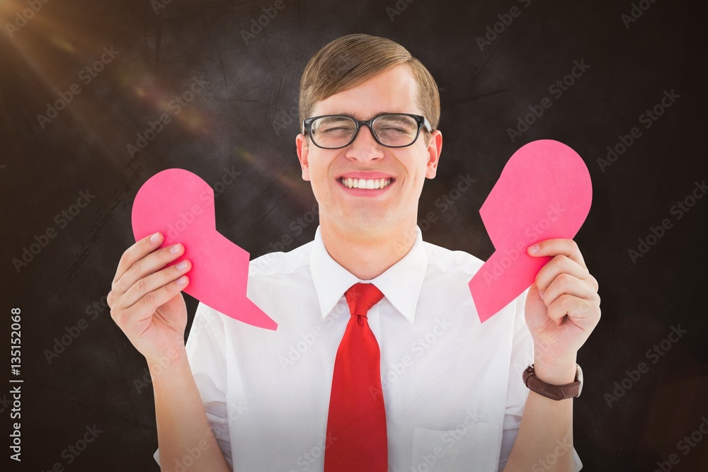 Composite image of geeky hipster holding a broken heart card