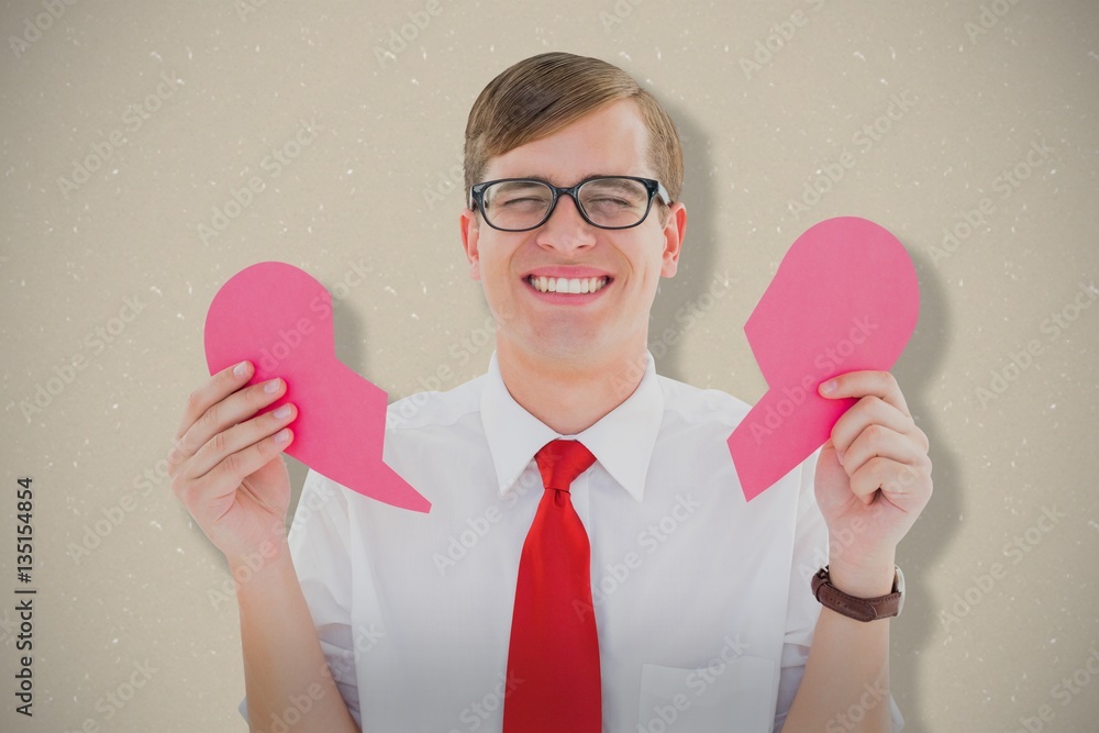 Composite image of geeky hipster holding a broken heart card