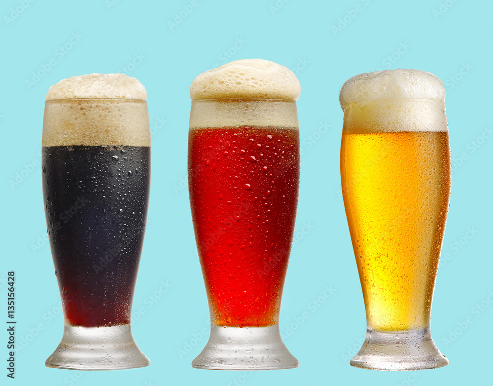 various beer glasses on blue background