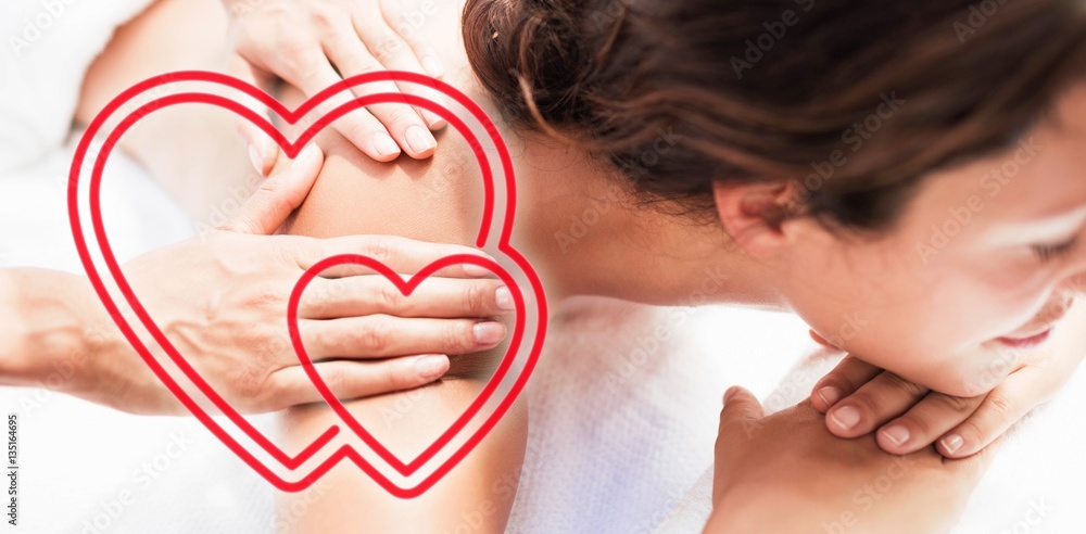 Composite image of a woman receiving a massage with love hearts