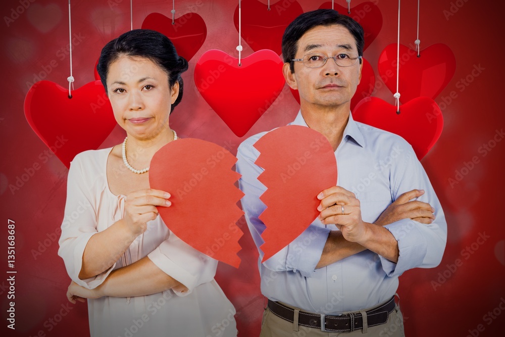 Composite image of couple holding broken heart 3d