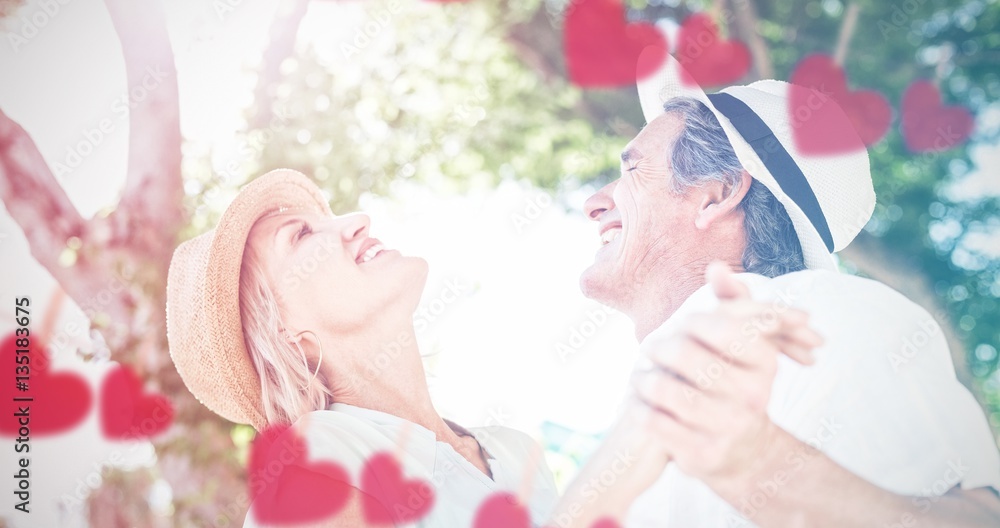 Composite image of hearts hanging on a line