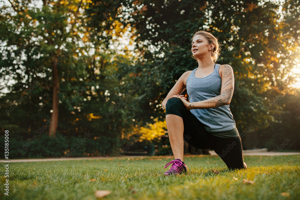 Young woman stretching before jogging