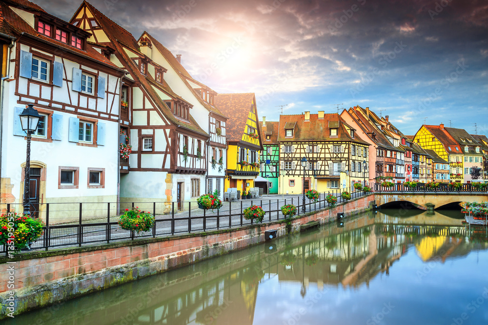 Famous medieval half-timbered facades reflecting in water, Colmar, France