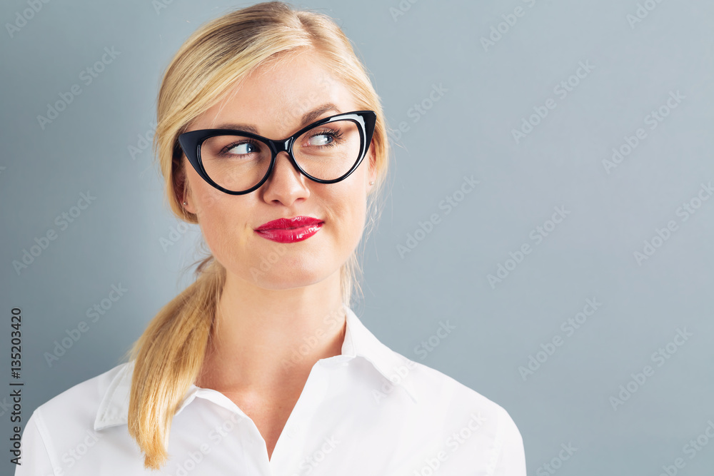 Young blonde businesswoman in black glasses