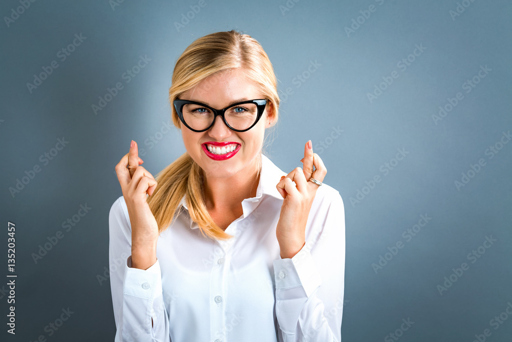 Young woman wishing for good luck