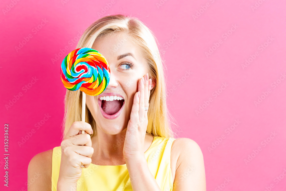 Young woman holding a lollipop