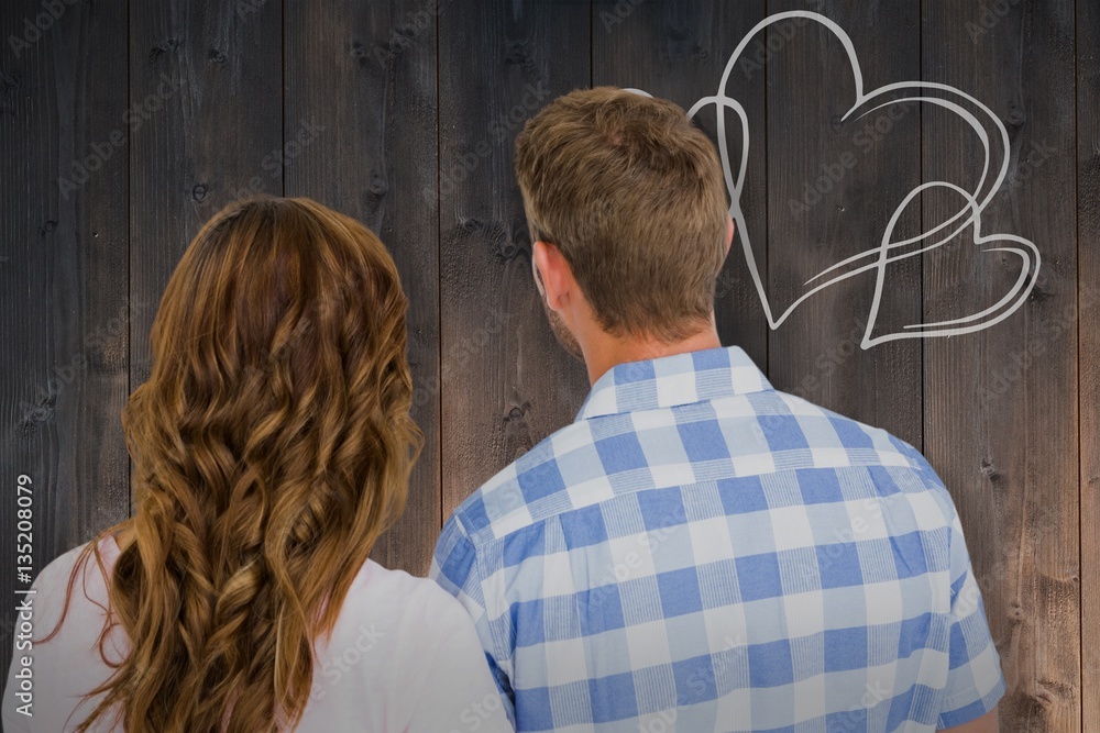 Composite image of rear view of young couple standing