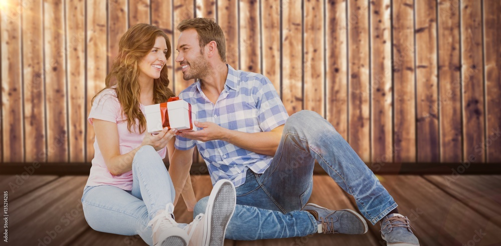 Composite image of happy man giving gift to woman