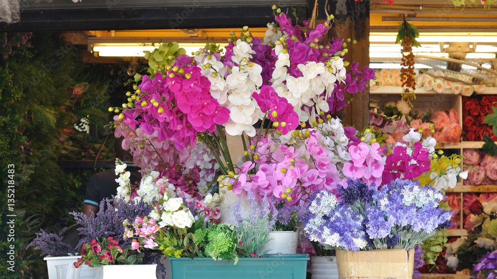 Artificial orchid flowers sale on market fair.