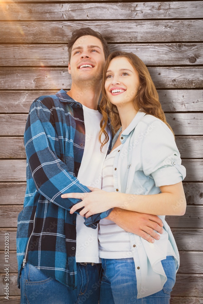 Composite image of couple standing and looking away