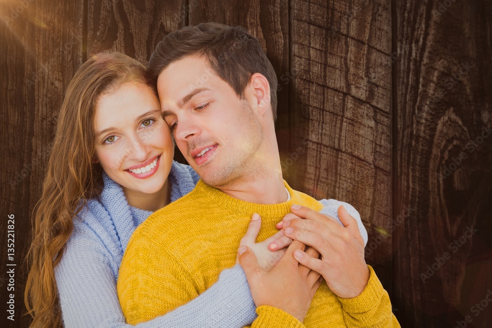 Composite image of smiling couple embracing 