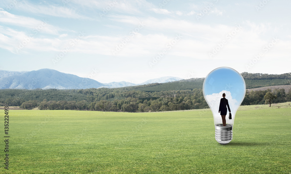 Businesswoman inside light bulb