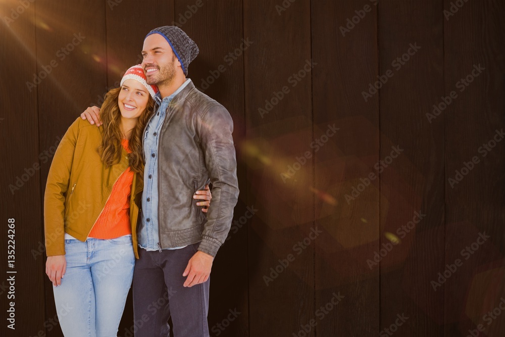 Composite image of young couple embracing and looking away