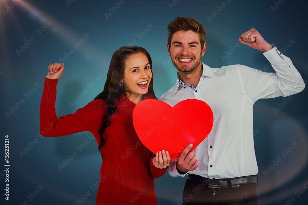 Composite image of cheerful couple holding paper heart