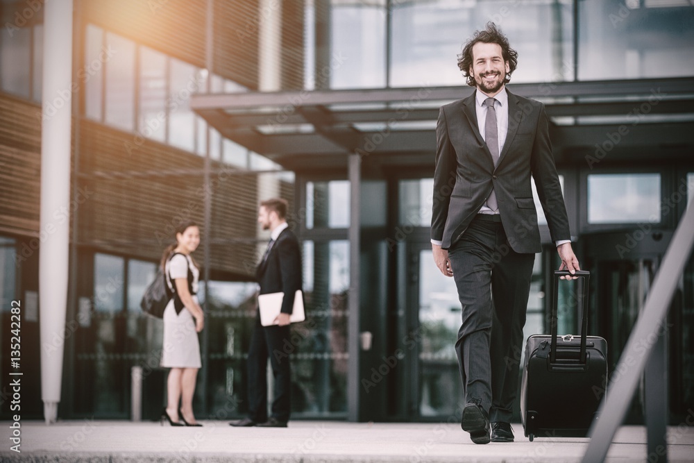 Businessman walking with suitcase