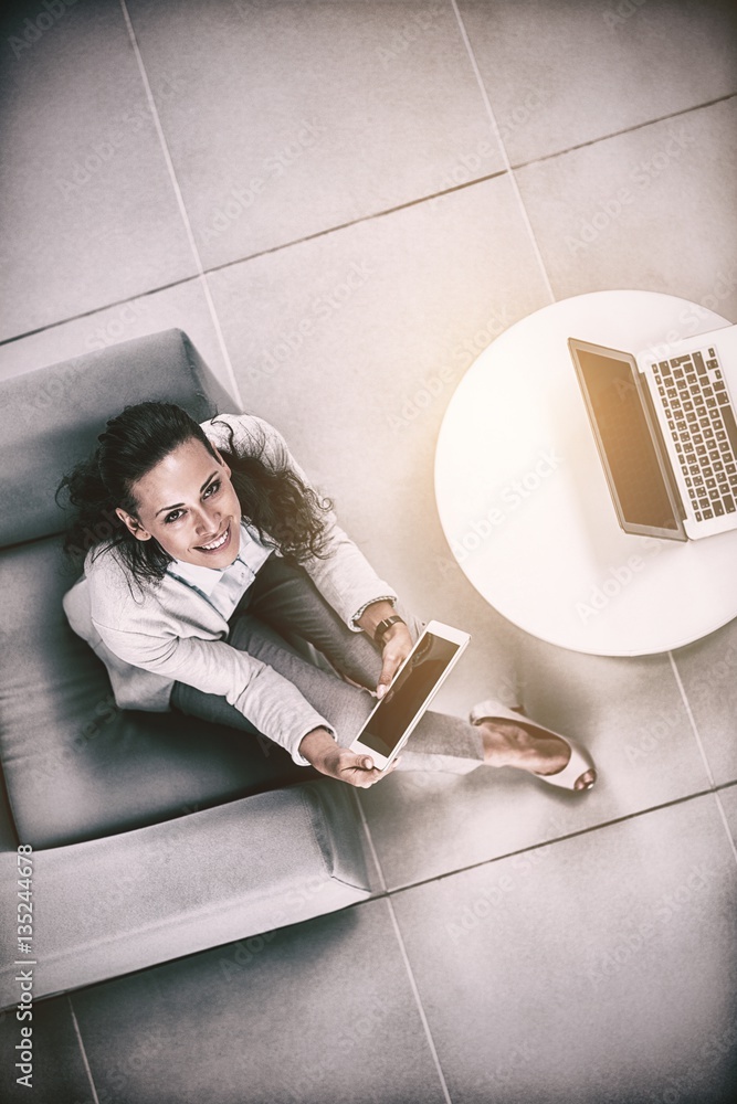 Portrait of businesswoman holding digital tablet