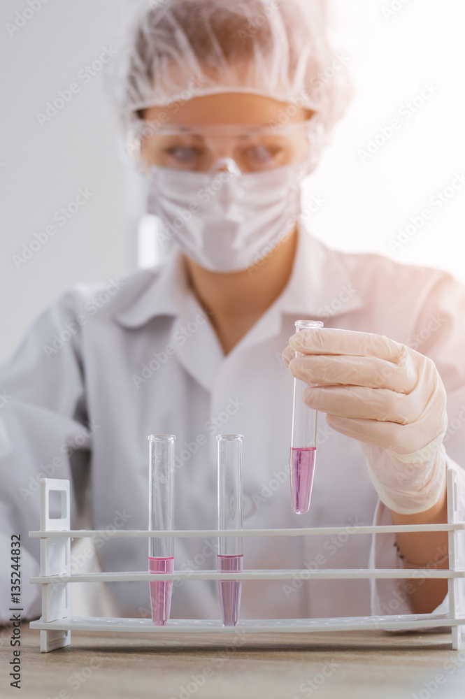 Scientis with test tube making research in clinical laboratory