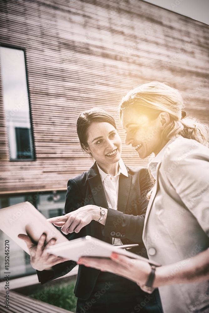 Businesswomen using laptop and digital tablet