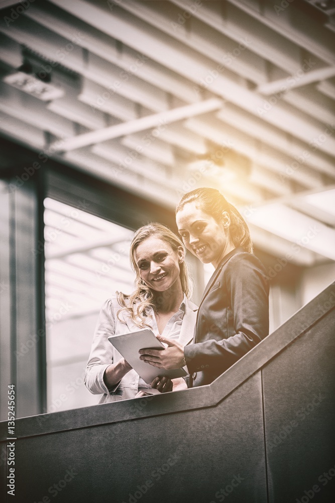 Cheerful businesswomen using digital tablet 