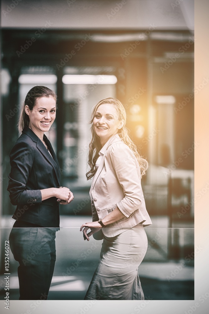 Happy businesswomen standing in office