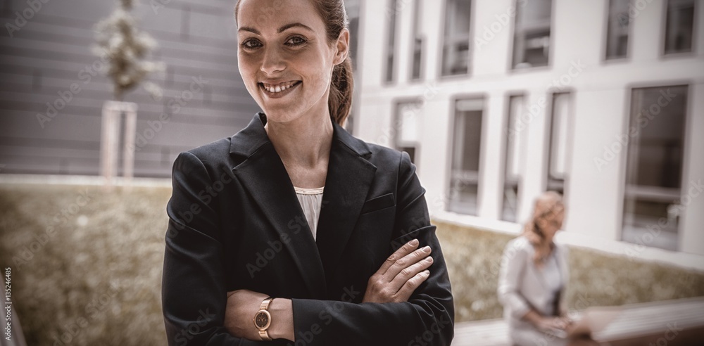 Smiling businesswoman standing in office premises