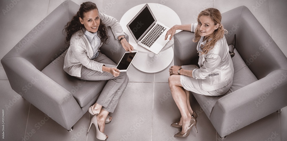 Portrait of businesswomen with laptop and digital tablet 