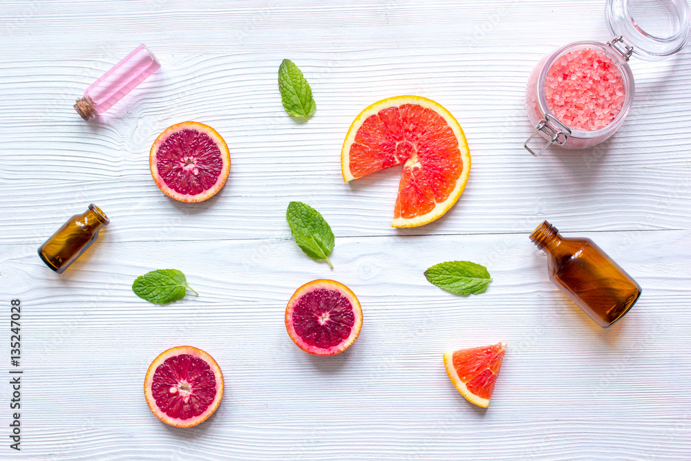 organic cosmetic with citrus on wooden background top view