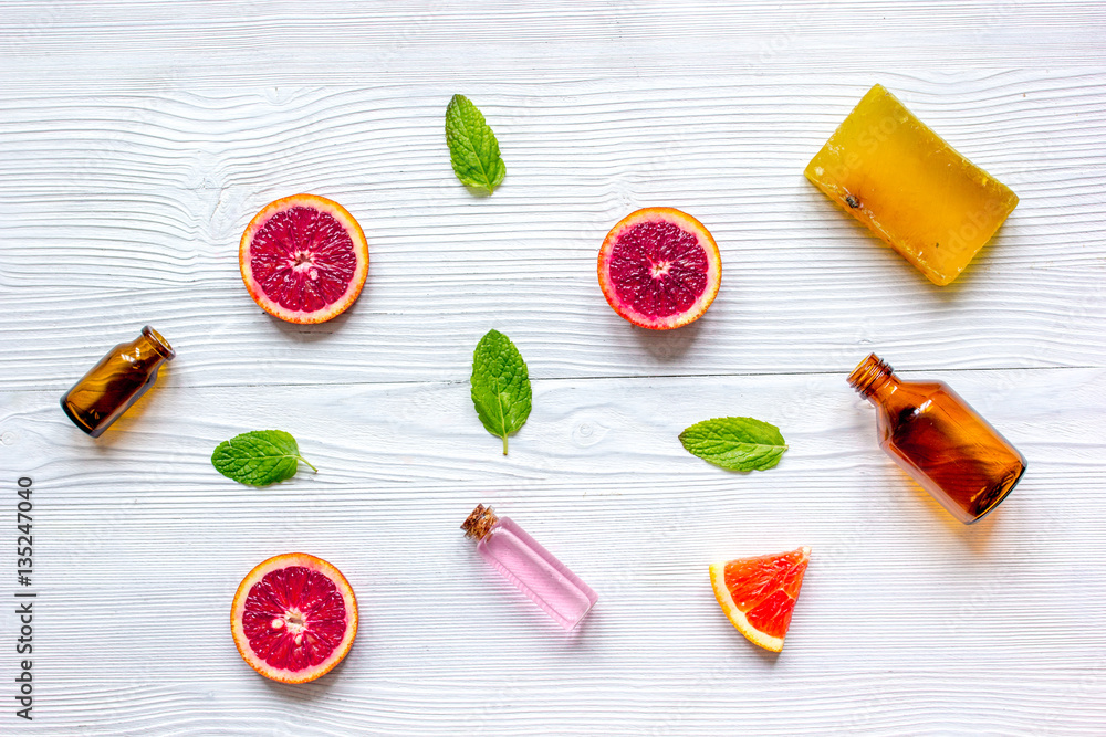 organic cosmetic with citrus on wooden background top view