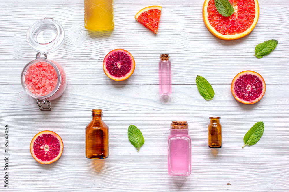 organic cosmetic with citrus on wooden background top view