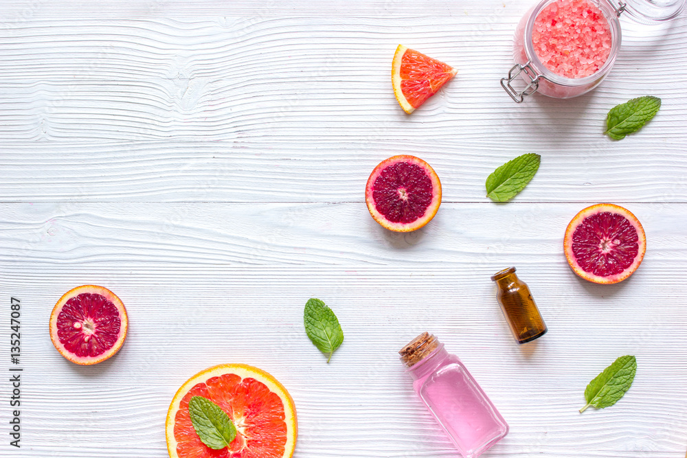 organic cosmetic with citrus on wooden background top view