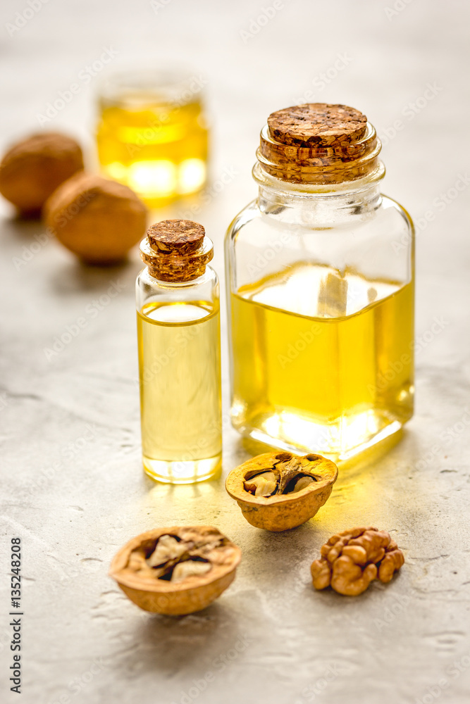 cosmetic and therapeutic walnut oil on gray background