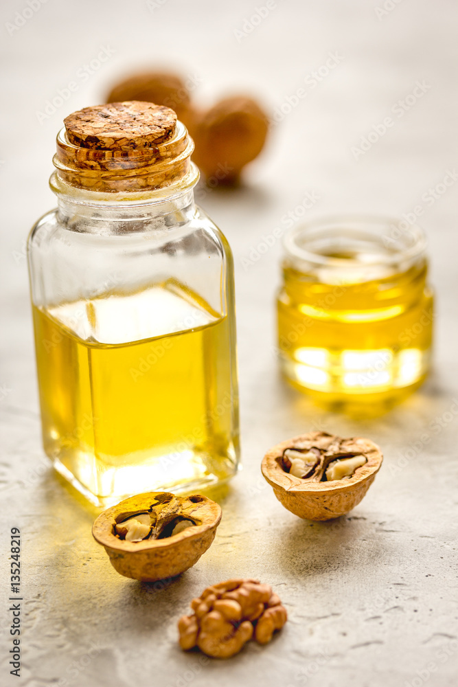 cosmetic and therapeutic walnut oil on gray background