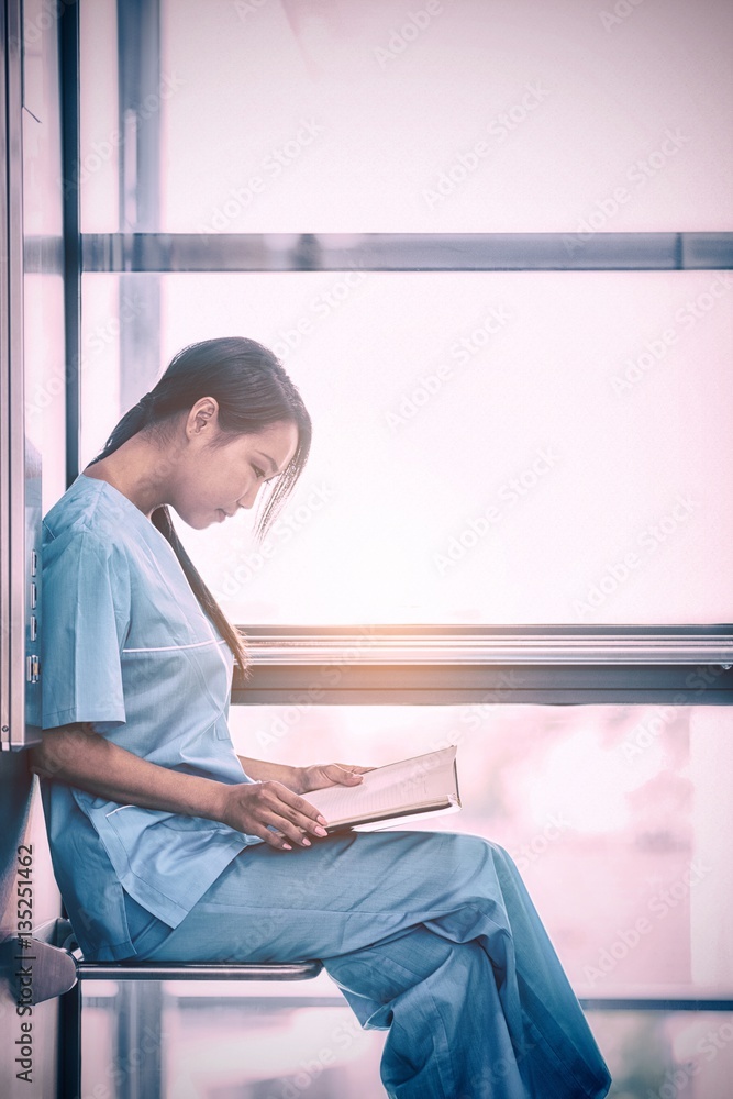 Side view of nurse looking at diary 