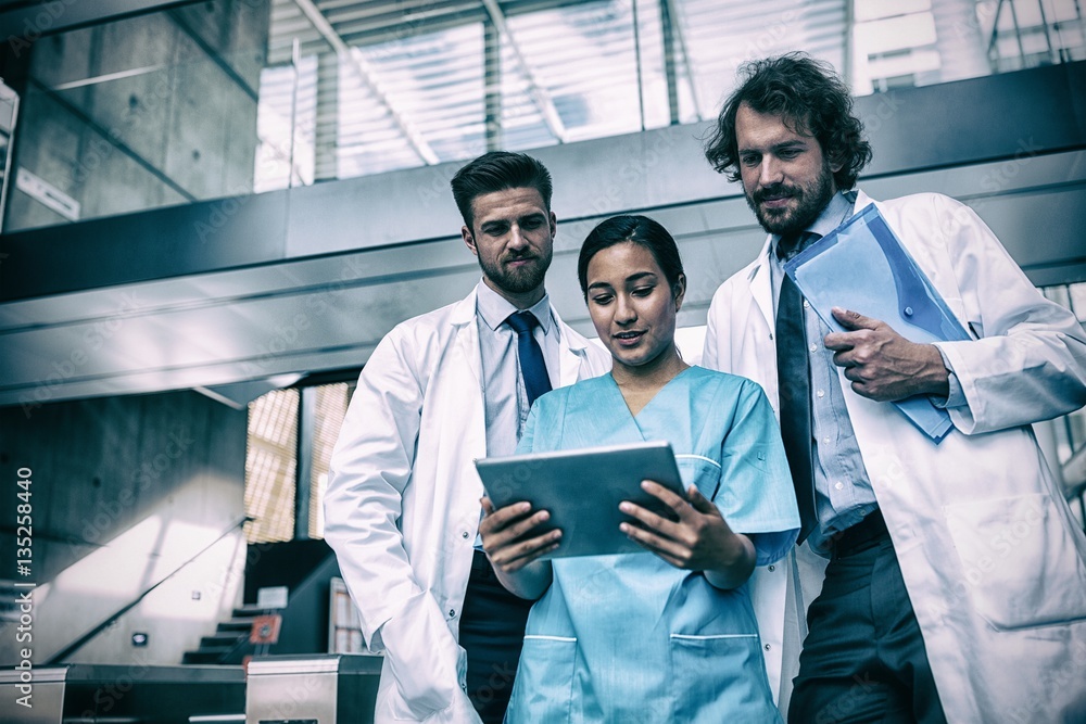 Doctors and nurse looking at digital tablet