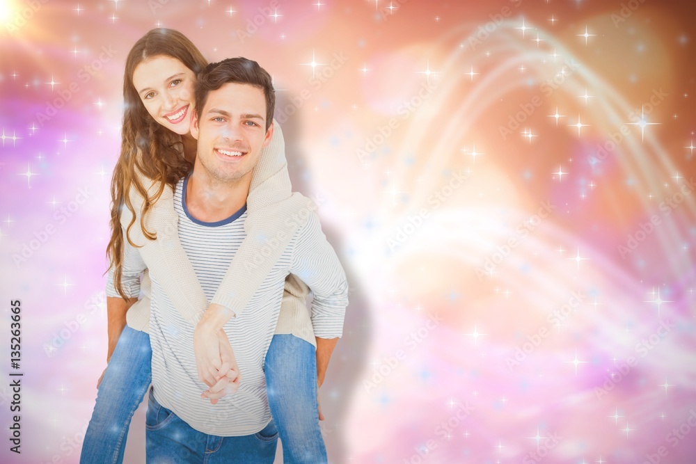 Composite image of portrait of smiling young couple piggybacking