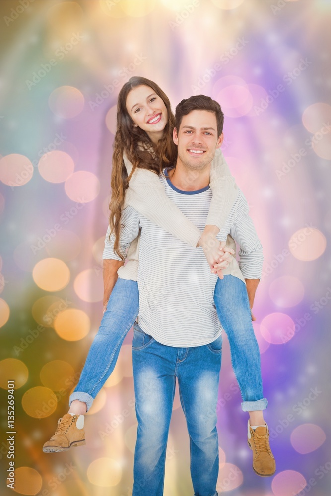 Composite image of portrait of happy young couple piggybacking