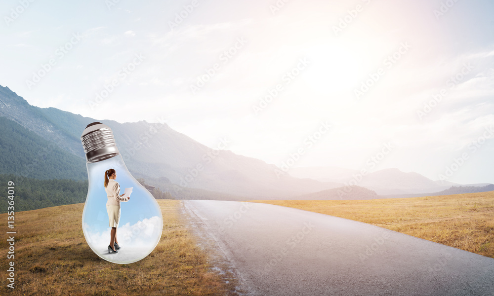 Businesswoman inside light bulb