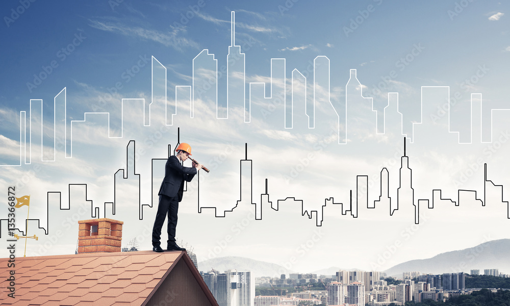 Engineer man standing on roof and looking in spyglass. Mixed med