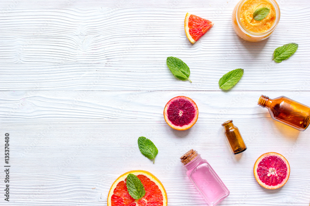 organic cosmetic with citrus on wooden background top view