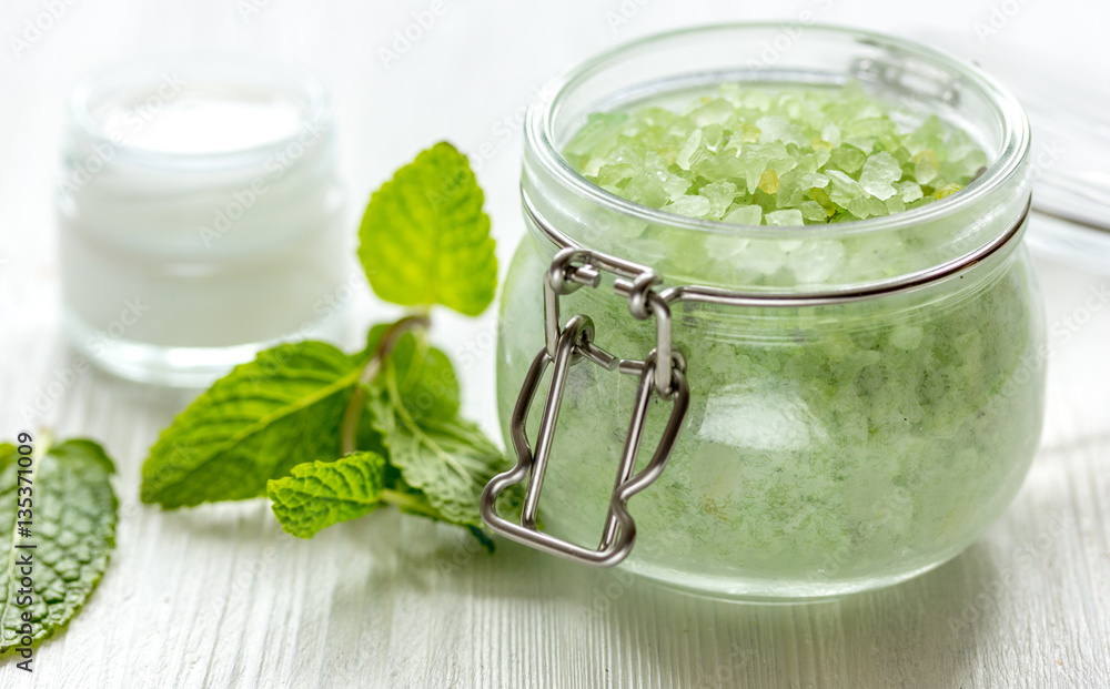 organic cosmetics with herbal extracts of mint on wooden background