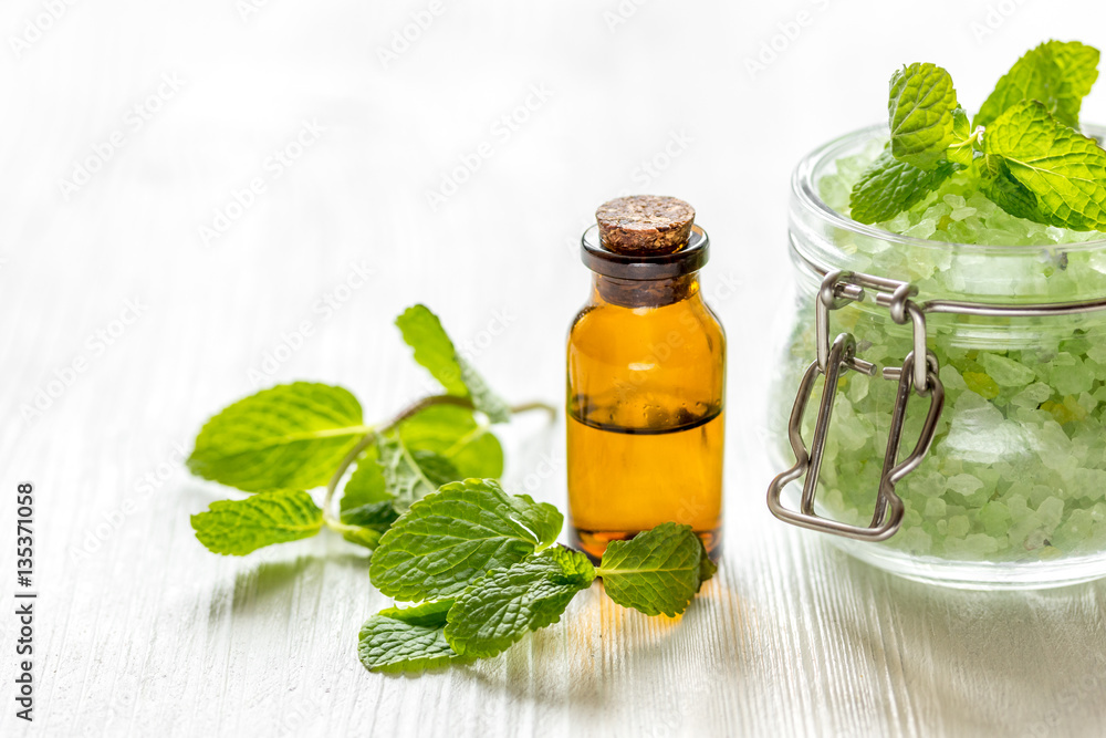 organic cosmetics with herbal extracts of mint on wooden background