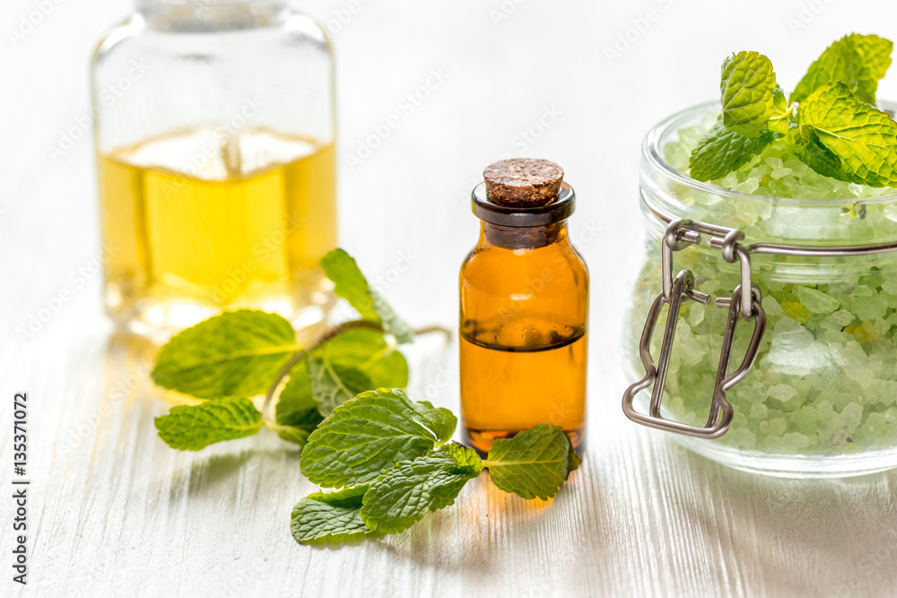 organic cosmetics with herbal extracts of mint on wooden background